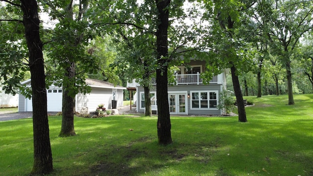 114 Bay View Rd, Otter Tail Twp, MN 56571 - view of grassy yard with a balcony, french doors, and a detached garage
