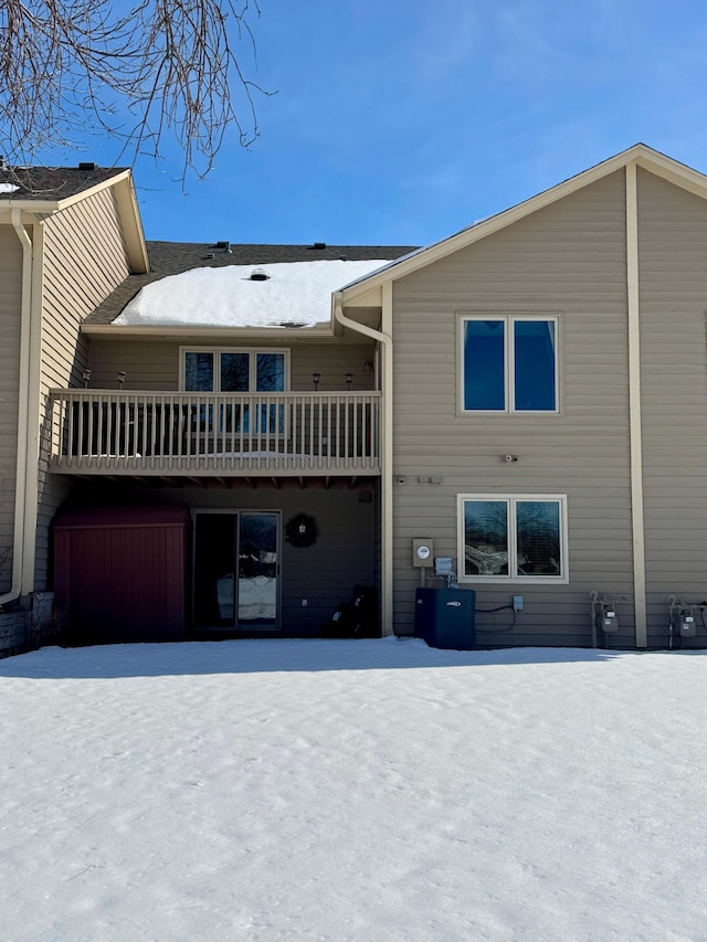 view of snow covered rear of property