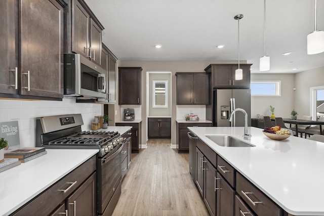 kitchen featuring dark brown cabinets, appliances with stainless steel finishes, and a sink