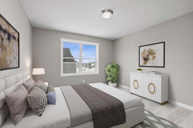 carpeted bedroom featuring baseboards