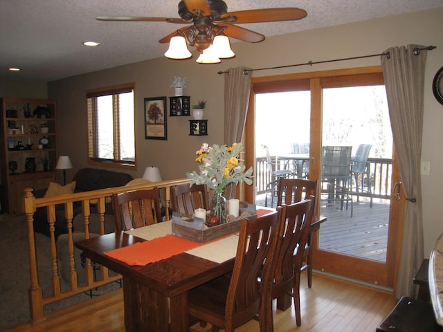 dining area featuring ceiling fan, a textured ceiling, and light wood-style floors