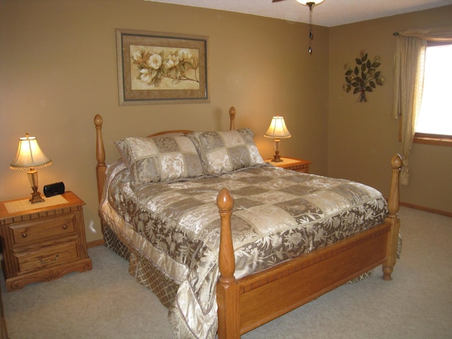 bedroom with baseboards and light carpet