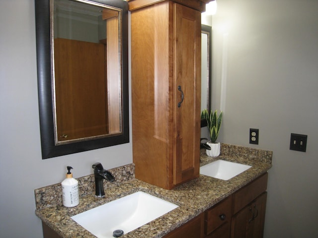 bathroom featuring a sink and double vanity