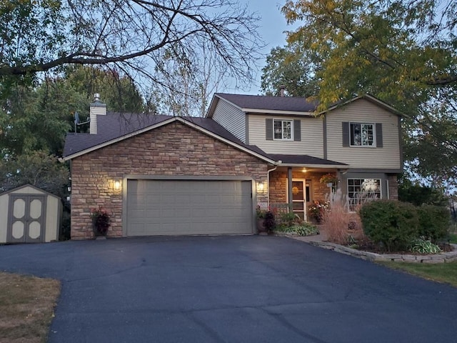 traditional-style house with aphalt driveway, a shed, a chimney, an outdoor structure, and an attached garage