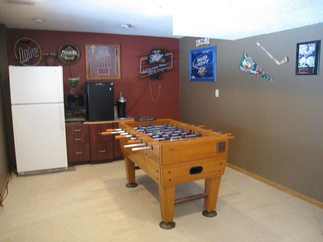 playroom featuring baseboards and light carpet