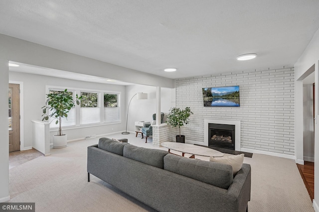 living room featuring visible vents, a fireplace, and baseboards