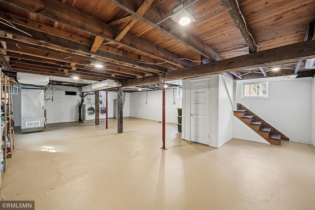 basement featuring stairway, independent washer and dryer, and visible vents