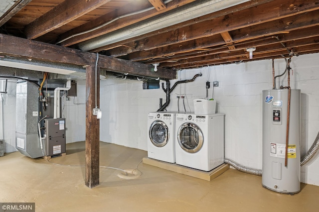 unfinished below grade area featuring heating unit, water heater, and washer and clothes dryer