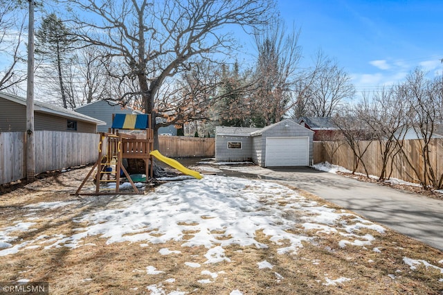 exterior space with an outbuilding, a playground, and fence