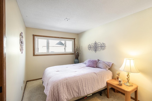 carpeted bedroom with a textured ceiling