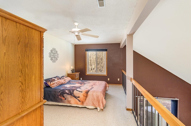 bedroom with visible vents, a ceiling fan, a textured ceiling, carpet, and baseboards