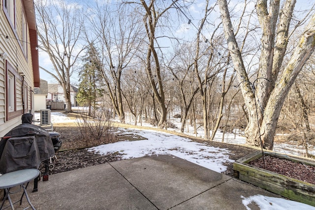 yard layered in snow featuring a patio area