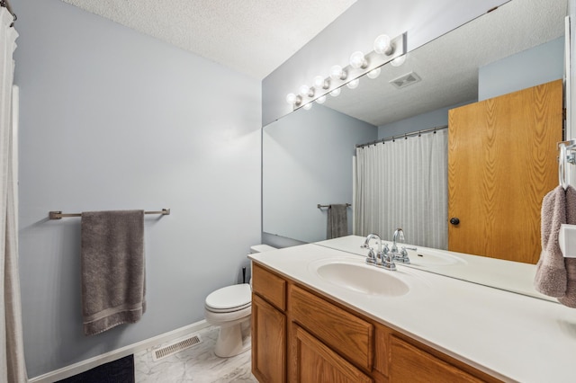 full bath featuring vanity, toilet, visible vents, and a textured ceiling