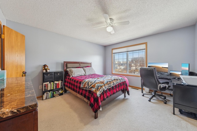 bedroom with a textured ceiling, carpet flooring, baseboards, and ceiling fan