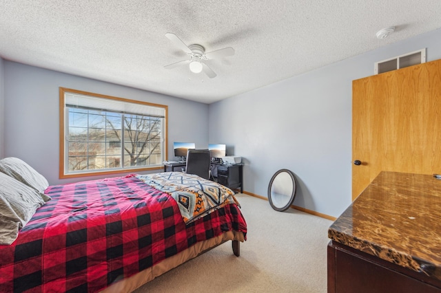 bedroom featuring ceiling fan, a textured ceiling, baseboards, and carpet floors