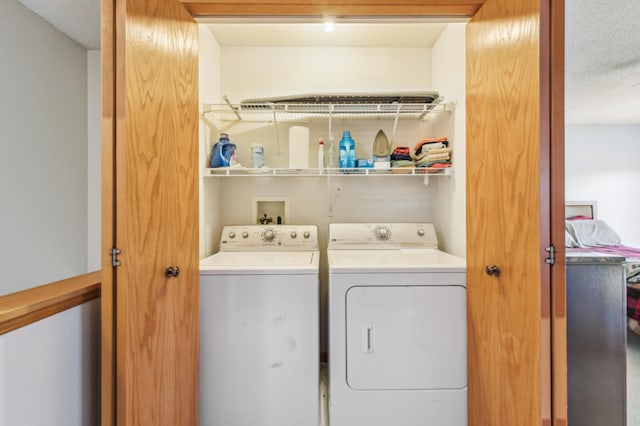 laundry area with washing machine and clothes dryer and laundry area