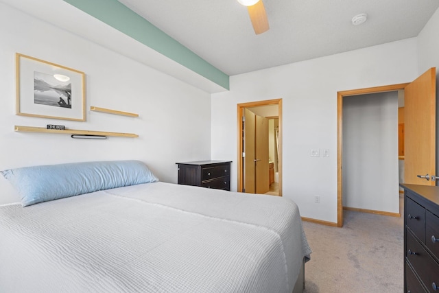 bedroom featuring baseboards, light colored carpet, and ceiling fan