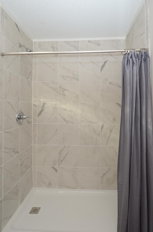 bathroom with tiled shower