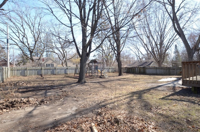 view of yard featuring a fenced backyard and a playground