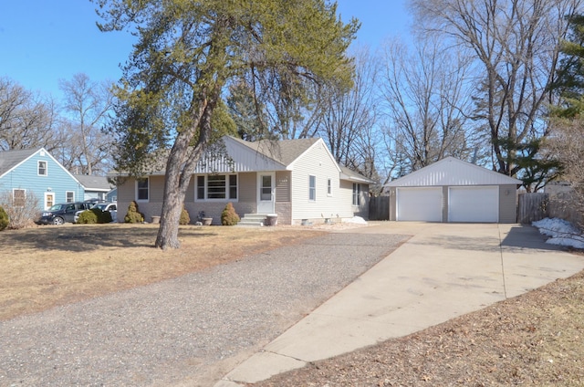 view of front of property with a detached garage, an outbuilding, and brick siding