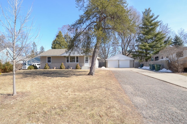 ranch-style home with a detached garage, an outdoor structure, and fence