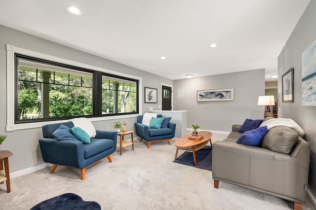 living area featuring recessed lighting, baseboards, and carpet