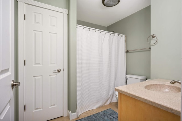 bathroom featuring tile patterned floors, a shower with curtain, toilet, and vanity