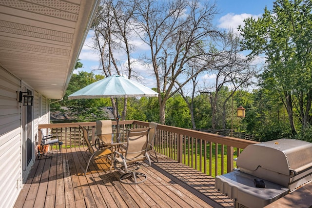 deck with outdoor dining area and a grill