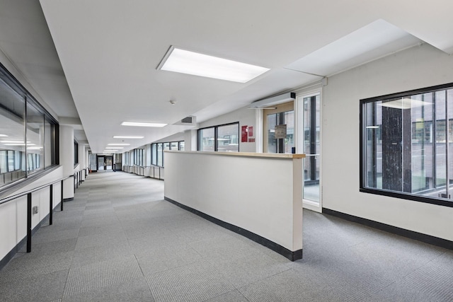 hall featuring baseboards