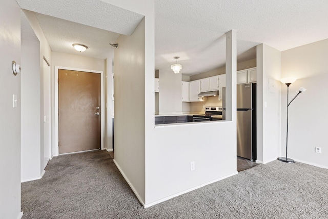 kitchen featuring under cabinet range hood, carpet floors, appliances with stainless steel finishes, a textured ceiling, and white cabinetry