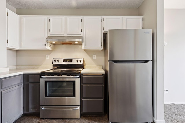 kitchen with light countertops, white cabinets, under cabinet range hood, and stainless steel appliances