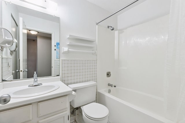 bathroom featuring shower / bath combo with shower curtain, toilet, tile walls, wainscoting, and vanity