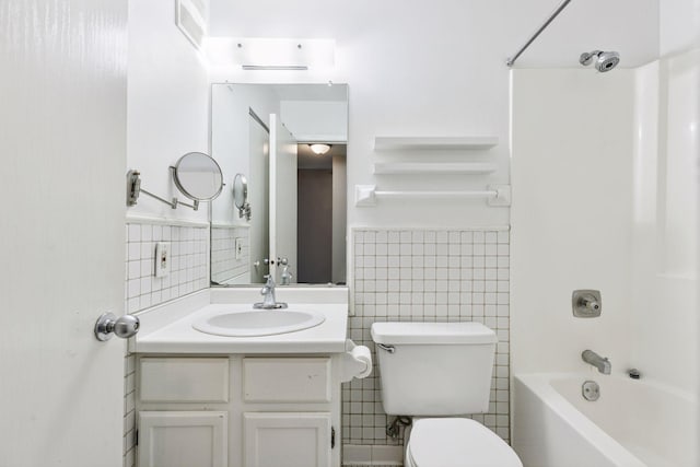 full bath with visible vents, toilet, shower / washtub combination, tile walls, and vanity