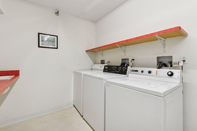 laundry room with baseboards, laundry area, and washing machine and clothes dryer