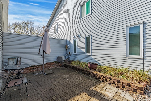 exterior space with central air condition unit and a patio