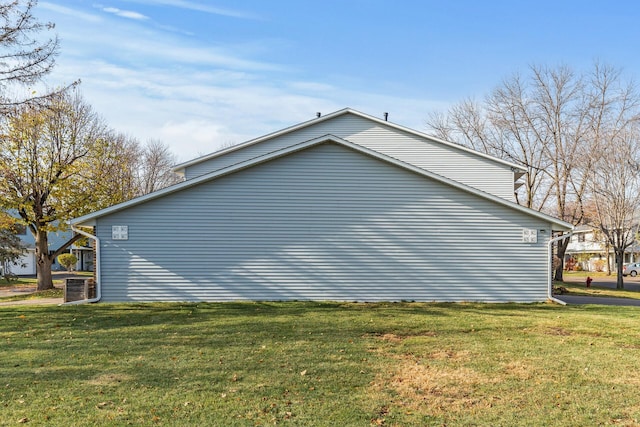 view of side of property with a lawn