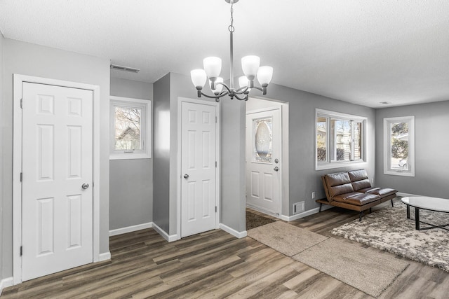 entrance foyer featuring visible vents, plenty of natural light, and wood finished floors