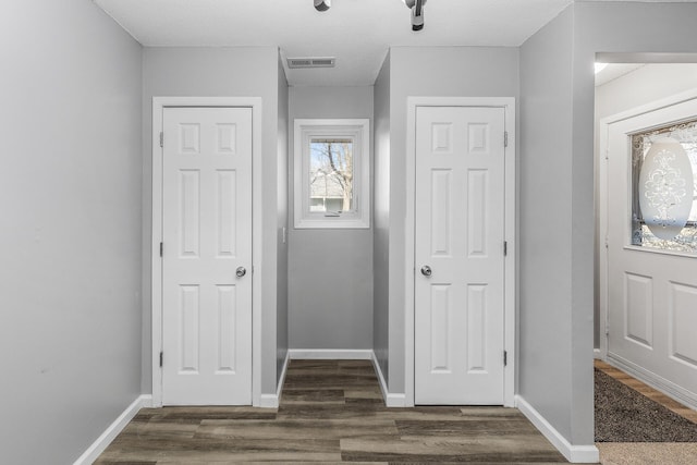 entrance foyer with baseboards and dark wood-style flooring