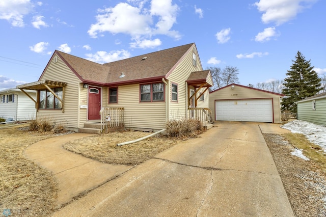 bungalow-style house featuring a garage, roof with shingles, and an outdoor structure