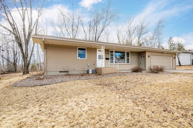 single story home featuring driveway, covered porch, a garage, and central air condition unit