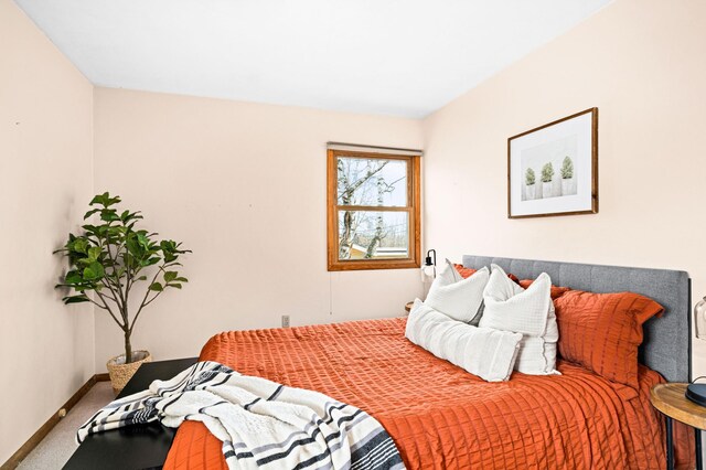 carpeted bedroom featuring baseboards