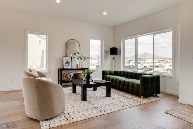 living room featuring light wood-style floors, baseboards, and recessed lighting