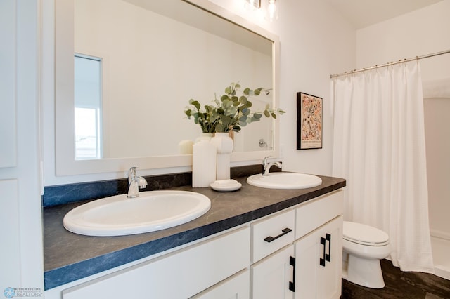 bathroom with a sink, toilet, double vanity, and a shower with shower curtain