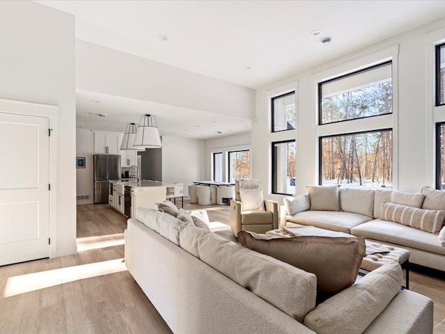 living area featuring a high ceiling and light wood-type flooring