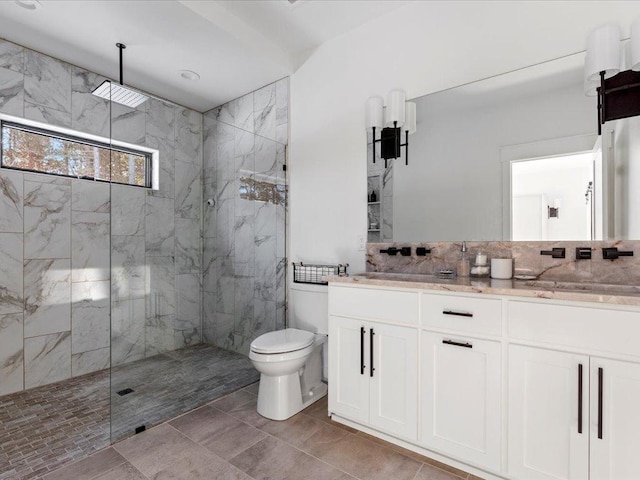 bathroom with vanity, toilet, and a marble finish shower