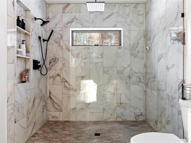 bathroom with toilet and a shower stall