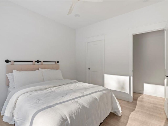 bedroom with light wood-style floors and a ceiling fan