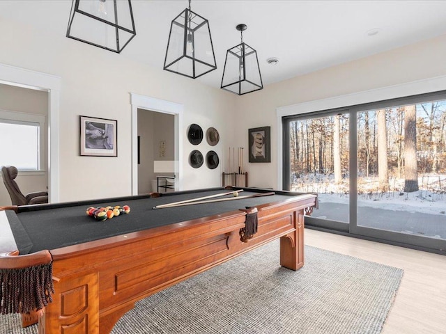 playroom with a wealth of natural light, light wood-style floors, and pool table