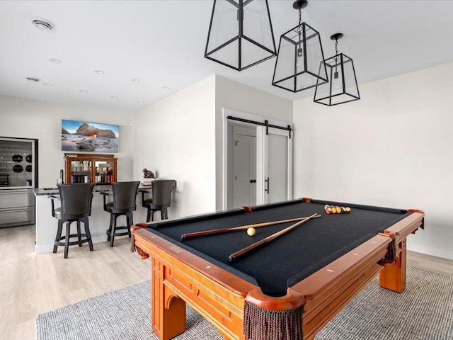 playroom featuring visible vents, light wood-style flooring, pool table, and a barn door