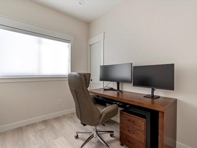 office space with light wood-style floors and baseboards